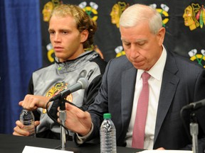 Chicago Blackhawks Patrick Kane, left, and John McDonough wait to answer questions during a media availability on the first day of NHL hockey training camp at the Compton Family Ice Center on the campus of the University of Notre Dame in South Bend, Ind., Thursday Sept. 17, 2015. (AP Photo/Joe Raymond)