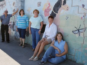 Members of the Fall Fair committee take a quick break while getting things ready for the Kingston and District Agricultural Society's 185th Fall Fair at the Memorial Centre in Kingston on Tuesday. (Julia McKay/The Whig-Standard)