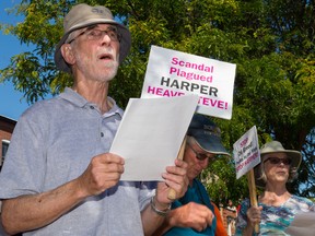 Tim Miller/The Intelligencer
Rob Williams, spokesperson for Fair Vote Bay of Quinte, joins a Harperman sing-a-long protest on Thursday in Picton.