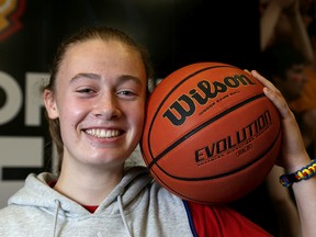 Bridget Mulholland of Regiopolis-Notre Dame smiles after committing to the Queen's Gaels women's basketball team for the 2016-17 season at a media conference at Queen's University’s Athletic and Recreation Centre on Thursday. (Ian MacAlpine/The Whig-Standard)