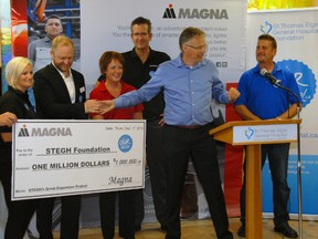 St. Thomas Elgin General Hospital Foundation executive director Paul Jenkins, second from left, accepts a $1 million gift from Magna.