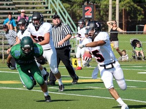 Northern Vikings quarterback Kobe Lundy points while running away from St. Pat's Fighting Irish defender Sean Fraser during the teams' senior boy's high school football game Thursday afternoon at Norm Perry Park. The Vikings shut out St. Pat's 19-0. (Terry Bridge, The Observer)