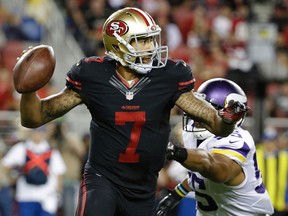 San Francisco 49ers quarterback Colin Kaepernick rolls out to pass as Minnesota Vikings outside linebacker Anthony Barr applies pressure during the second half of an NFL football game in Santa Clara, Calif., on Sept. 14, 2015. (AP Photo/Marcio Jose Sanchez)