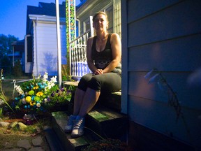 Suzanne Irwin, common-law wife of Steve Sinclair, sits on the front steps of their Vancouver Street home in London on Thursday. Sinclair was shot and killed outside a Hamilton Road social club following a birthday celebration for Irwin on September 6. Craig Glover/The London Free Press/Postmedia Network