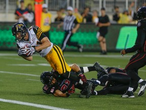 Tiger-Cats’ Matt Coates gets the ball in for a touchdown during pre-season play against the RedBlacks. Coates also caught a TD against the Argos last week. (Dave Thomas/Toronto Sun)