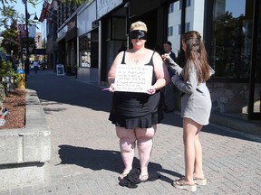 Sheila Bianconi stood up for a Body Image Campaign that began in the UK from a group out of Australia. Women in the USA have posted their video's and Bianconi hopes to draw attention to the cause by standing in downtown Sudbury at the corner of Larch and Durham Street on Thursday September 17, 2015.. Bianconi, has chosen to share her story about her struggles by standing blindfolded while asking complete strangers to draw a Heart on her body. Gino Donato/Sudbury Star/Postmedia Network