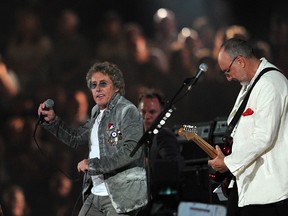 Roger Daltry (L) and Pete Townshend of the British rock band The Who perform at the Olympic stadium during the closing ceremony of the 2012 London Olympic Games in London on August 12, 2012. Rio de Janeiro will host the 2016 Olympic Games.  AFP PHOTO / CARL COURT