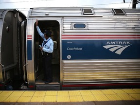 A train conductor signals from an Amtrak train September 3, 2015. Alex Wong/Getty Images/AFP