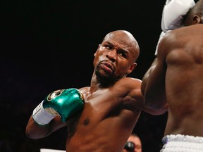 Floyd Mayweather Jr. hits Andre Berto during their welterweight title fight Saturday, Sept. 12, 2015, in Las Vegas. (AP Photo/John Locher)