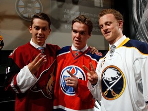 First pick Connor McDavid (C) of the Edmonton Oilers, second pick Jack Eichel (R) of the Buffalo Sabres and third pick Dylan Strome (L) of the Arizona Coyotes pose at the 2015 NHL Draft at BB&T Center on June 26, 2015 in Sunrise, Florida. The league's three worst teams from last year are much improved as training camps open. (Bruce Bennett/Getty Images/AFP)