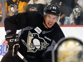 Pittsburgh Penguins' Sidney Crosby looks to shoot on goalie Marc-Andre Fleury during NHL hockey training camp, Friday, Sept. 18, 2015, in Cranberry Township, Pa. (AP Photo/Keith Srakocic)