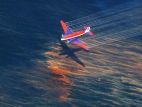 The crew of a Basler BT-67 fixed wing aircraft release oil dispersant over an oil discharge from the mobile offshore drilling unit, Deepwater Horizon, off the shore of Louisiana, in this May 5, 2010 handout photograph.  REUTERS/Stephen Lehmann/U.S. Coast Guard/Handout