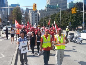 OTTAWA - Sept 18, 201 5 - Protesting airport cabbies march on Laurier Ave. outside City Hall on Friday, Sept. 18, 2015. (JON WILLING/OTTAWA SUN/POSTMEDIA NETWORK)