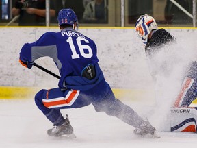 Teddy Purcell takes a shot on Ben Scrivens during the first day of Oilers camp at the Leduc Recreation Centre on Friday. (Ian Kucerak, Edmonton Sun)