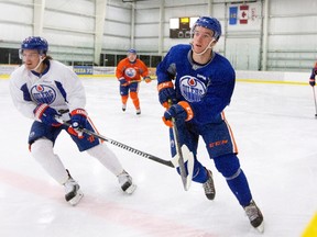 Oilers centre Anton Lander, left, takes part in a drill with teammate Connor McDavid during the first day of camp at the Leduc Recreation Centre. (The Canadian Press)