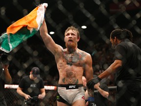Conor McGregor celebrates after defeating Chad Mendes during their interim featherweight title bout at UFC 189 on Saturday, July 11, 2015, in Las Vegas. (AP Photo/John Locher)
