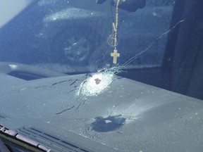 A bullet hole is shown in a windshield of a car that was traveling on Interstate 10 in Phoenix, Arizona in the handout photo released to Reuters, September 1, 2015.  REUTERS/Arizona Department of Public Safety/Handout