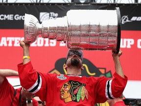 Michal Rozsival of the Chicago Blackhawks kisses the Stanley Cup trophy during the Stanley Cup Championship Rally at Soldier Field in Chicago on June 18, 2015. (Jonathan Daniel/Getty Images)