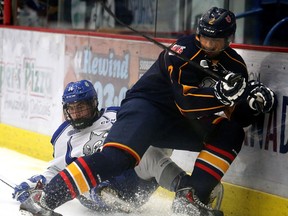 Sudbury Wolves Owen Lane and Barrie Colts Rocky Kaura fight for the puck during OHL exhibition action from the Sudbury Community Arena in Sudbury in this file photo.
The pair face each other tonight, Friday, Dec. 4, in Sudbury.
Gino Donato/Sudbury Star/Postmedia Network