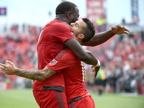 Toronto FC forward Sebastian Giovinco celebrates with forward Jozy Altidore after scoring against Colorado Rapids in the first half at BMO Field in Toronto on Sept. 19, 2015. (Dan Hamilton/USA TODAY Sports)