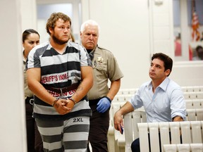 Leslie Allen Merritt Jr., makes his way to appear before a judge at the Maricopa County Sheriff's Office on Saturday, Sept. 19, 2015, in Phoenix. The landscaper is the suspect in a series of Phoenix freeway shootings and was arrested Friday after trying to sell a gun at a pawn shop.  (Rob Schumacher/The Arizona Republic via AP, Pool)