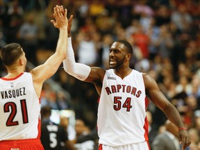 The Raptors' Patrick Patterson celebrates with teammate Greivis Vasquez last season. (Stan Behal/Toronto Sun)