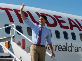 Liberal Leader Justin Trudeau waves to supporters as he exits his campaign plane on Friday, Sept. 18, 2015, in Montreal. THE CANADIAN PRESS/Paul Chiasson