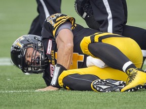 Hamilton Tiger-Cats quarterback Zach Collaros grimaces after being injured on a tackle against the Edmonton Eskimos in Hamilton on Saturday. (REUTERS/Mark Blinch)