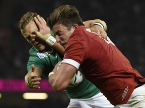 Canada’s wing DTH van der Merwe (right) blocks Ireland’s fly half Ian Madigan to score Canada’s only try during its 50-7 loss to Ireland in a Pool D game of the 2015 Rugby World Cup on Sept. 19, 2015 in Cardiff, Wales. (LOIC VENANCE/AFP)