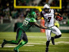 Ottawa Redblacks wide receiver Maurice Price (R) tries to evade Saskatchewan Roughriders defensive back Tristan Jackson during the first half of their CFL football game in Regina on Sept. 19. (Reuters)