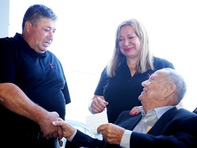 Gianna and Tony Nero are congratulated by John Maslack, former owner of the building, as friends family and business partners gathered for the grand opening of the new Carstar Collision & Glass Service at 3175 The Kingsway. Gino Donato/Sudbury Star