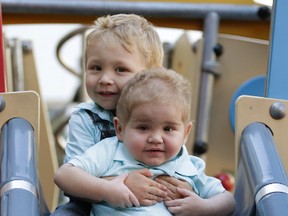 Calvin Meredith (foreground) with his brother, Dalton, enjoy the Ronald McDonald House playground on Thursday September 17, 2015. (Craig Robertson/Toronto Sun)