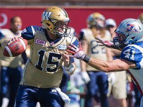 Winnipeg Blue Bombers quarterback Matt Nichols, left, is tackled by Montreal Alouettes' Kyler Elsworth during first half CFL football action in Montreal, Sunday, Sept. 20, 2015. THE CANADIAN PRESS/Graham Hughes