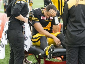 Hamilton Tiger-Cats quarterback Zach Collaros is looked after on the medical bench after being injured on a tackle against the Edmonton Eskimos during the first half of their CFL football game in Hamilton, Ontario, Canada, September 19, 2015. Collaros left the game after the play.  REUTERS/Mark Blinch