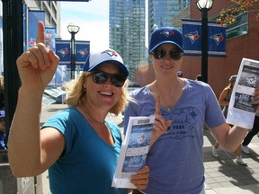 Blue Jays fans like Juli Miller, left, and Melanie Bevan said Sunday that the Jays' success this season should be enjoyed, and that the team's history of losing should be kept exactly there -- in history.  (TERRY DAVIDSON, Toronto Sun)
