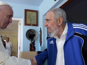 Pope Francis and Cuba's Fidel Castro shakes hands, in Havana, Cuba, Sunday, Sept. 20, 2015.  (AP Photo/Alex Castro)