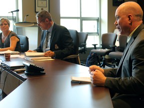 From left, Deputy Chief Antje McNeely and Chief of Police Gilles Larochelle listen to Staff Sgt. Greg Sands, in charge of special services, speak about Queen's University Homecoming arrangements at the Kingston Police Services Board meeting at Kingston Police Headquarters in Kingston, Ont. on Thursday September 17, 2015. Steph Crosier/Kingston Whig-Standard/Postmedia Network