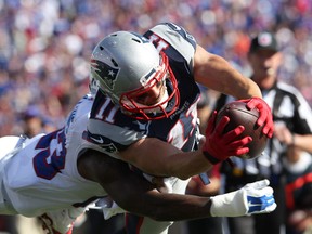Buffalo Bills strong safety Aaron Williams (23) dives to try and tackle New England Patriots wide receiver Julian Edelman (11) during the second half at Ralph Wilson Stadium. Patriots defeat the Bills 40 to 32.  Timothy T. Ludwig-USA TODAY Sports