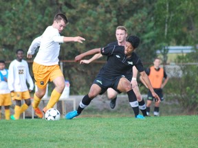 Cambrian College Golden Shield's Aaron Dent handles the ball against a Algonquin player during OCAA men's soccer play on Sunday at Cambrian College. The Golden Shield lost 2-0. Keith Dempsey/For The Sudbury Star