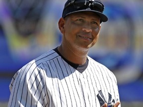 Alex Rodriguez of the New York Yankees holds gifts during a pregame ceremony at Yankee Stadium on Sept. 13, 2015, celebrating Rodriguez's 3,000th career hit. (ADAM HUNGER/Getty Images/AFP)