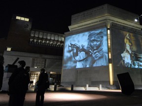 In this Monday, Nov. 20, 2006, file photo, images from Darfur and Chad are projected on the exterior walls of the United States Holocaust Memorial Museum in Washington. To try to predict and prevent mass killings, the museum is making both sophisticated statistical analysis and feedback from experts publicly available for the first time to produce early warnings that can help governments, policy makers, advocacy groups and scholars decide where to concentrate their efforts. The Early Warning Project online tool was announced Monday, Sept. 21, 2015. (AP Photo/Nick Wass)