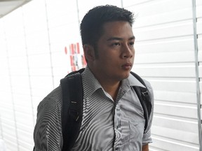 Filipino nurse Ello Ed Mundsel Bello arrives for his sentencing at a state court in Singapore on September 16, 2015, after he was found guilty last month of sedition and lying to the police for Facebook posts in which he insulted Singaporeans. The sentencing was postponed until September 21.  AFP PHOTO / ROSLAN RAHMAN