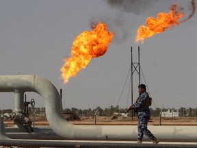 A member of the oil police force walks at Nahr Bin Umar oil field, north of Basra, southeast of Baghdad August 19, 2015.  REUTERS/Essam Al-Sudani