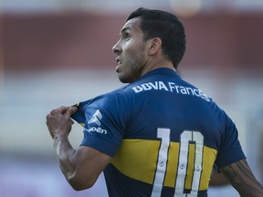 Boca Juniors' forward Carlos Tevez celebrates after scoring a goal against Argentinos Juniors during their Argentina First Division football match at Diego Armando Maradona stadium, on September 19, 2015.  Boca Juniors won by 3-1. AFP PHOTO / ALEJANDRO PAGNI