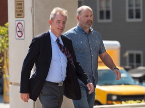 Dennis Oland walks with an unidentified friend at his trial in Saint John, N.B. on Wednesday, Sept. 16, 2015. A man who was among the first to arrive after businessman Richard Oland's body was found told Dennis Oland's murder trial Monday the first thing he noticed was a sickening smell. THE CANADIAN PRESS/Andrew Vaughan