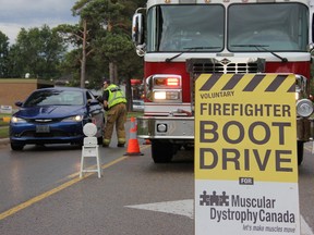 Volunteer firefighter from the Strathroy station on Metcalfe Street collecting donation during their annual Firefighter Boot Drive, Saturday, Sept. 19.