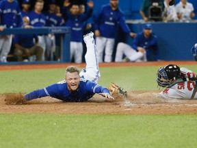 Blue Jays baserunner Josh Donaldson scores on an Edwin Encarnacion hit during eighth inning MLB action against the Red Sox in Toronto on Saturday, Sept. 19, 2015. (Stan Behal/Toronto Sun)