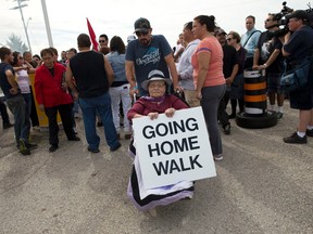 Barbara George, 83, is wheeled into the former military base at Camp Ipperwash as members of the Kettle and Stony Point First Nation celebrate the ratification of a deal that returns expropriated land to the band in Ipperwash, Ont. on Sunday September 20, 2015. (CRAIG GLOVER, The London Free Press)