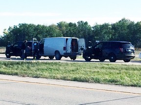 Manitoba's independent investigation unit investigate a scene just north of Winnipeg on Highway 59 near Highway 44 on Sept. 21, 2015. Winnipeg police officers shot and killed a 44-year-old man at the scene. (DENNIS FUERST/SELKIRK JOURNAL/POSTMEDIA NETWORK PHOTO)