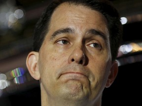Wisconsin governor and Republican candidate for president Scott Walker reacts during a campaign event at a diner in Amherst, New Hampshire, in this file photo taken July 16, 2015. Walker plans to drop out of the 2016 presidential race after determining he has no path to win, the New York Times reported on Monday, citing three unnamed Republicans familiar with Walker's decision. REUTERS/Dominick Reuter/Files